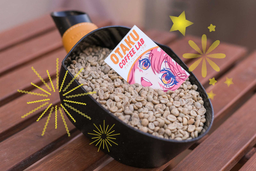 Image shows a giant coffee scoop holding a lot of raw green specialty coffee with an Otaku Coffee Lab card stuck into the coffee beans